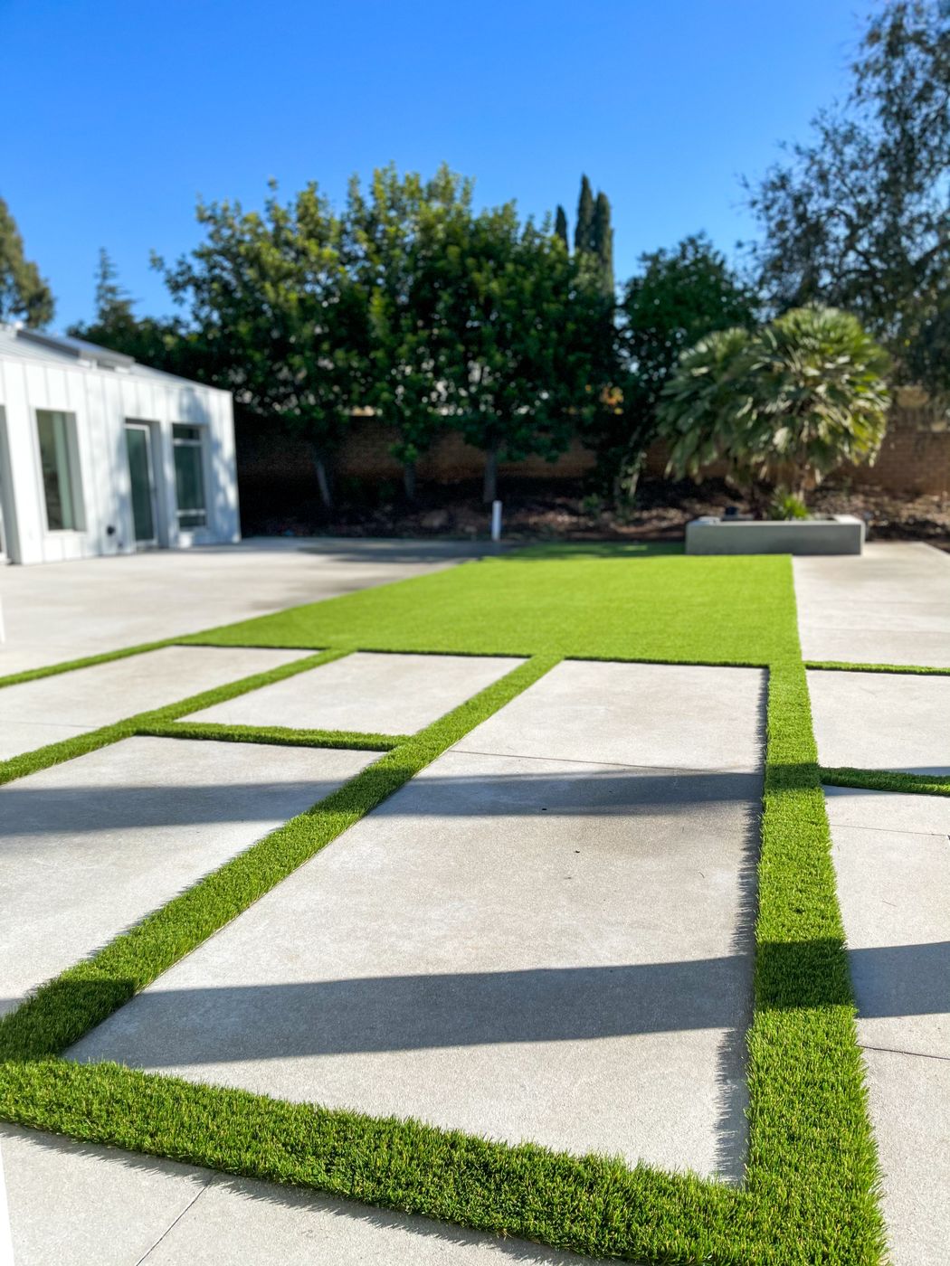 Backyard with synthetic turf and landscaping